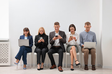 Obraz premium Group of people using different gadgets indoors. Modern technology