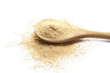 Yellow, golden maca organic powder pile in wooden spoon isolated on white, side view