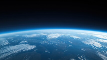 Earth's curve viewed from space, showing the atmosphere and land.