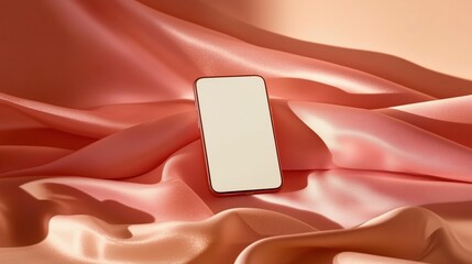 A modern smartphone rests on soft pink silk. Mockup for feminine branding.