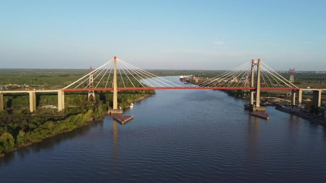 Panoramic view of the Zarate Brazo Largo complex moving away with a drone at sunset and with heavy traffic
