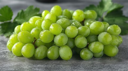 Fresh and Juicy Green Grapes with Water Droplets on a Gray Surface Surrounded by Leaves, Ideal for Healthy Snacking or Culinary Uses in Food Photography
