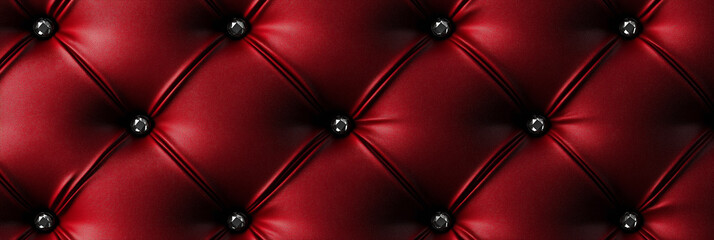 Fototapeta premium Luxurious red leather upholstery with crystal buttons forming a diamond pattern