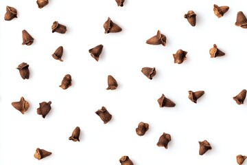Dried clove spices on a white surface viewed from above