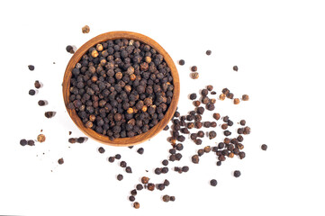 Black peppercorns (black pepper) in a wooden bowl isolated on a white background