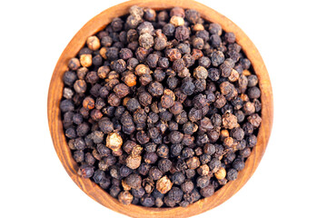Black peppercorns (black pepper) in a wooden bowl isolated on a white background