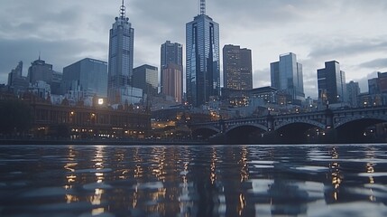 Obraz premium City skyline reflected in calm water at dusk.