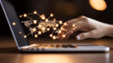 Hand interacting with global network on laptop.