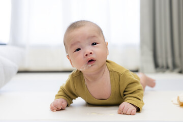 Baby relaxing on soft mat for tummy time