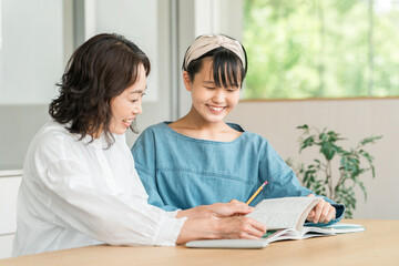 母親・教師・家庭教師・塾講師に勉強を教えてもらう中学生の女の子
