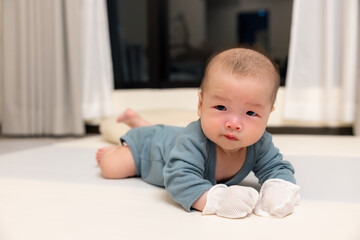 Fototapeta premium Newborn baby resting peacefully with mittens