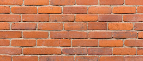 Fototapeta premium Worn brick wall with subtle texture and traces of old plaster, showcasing rustic charm