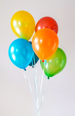 Bunch of bright balloons on a colored gray background. Concept of holidays, birthday, party