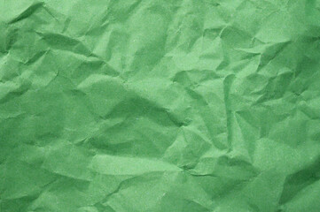 Obraz premium Full frame shot of crumpled light green paper sheet texture and background.