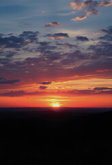 Panorama of dramatic sunset sky with setting sun, enhance, with white tones