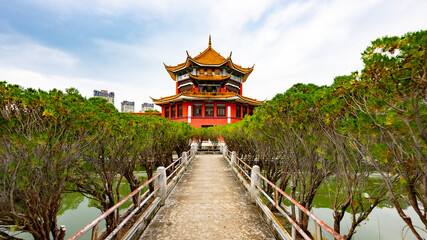 Naklejka premium Buddhist temple with a bridge over the lake in Yunnan Province