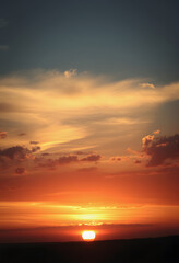 Obraz premium Panorama of dramatic sunset sky with setting sun, vintage, with white tones