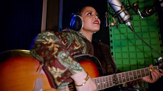 Girl vocalist records a song with the microphone