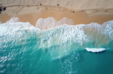 Fototapeta premium Aerial View of Turquoise Waves Crashing on Sandy Beach: A stunning aerial view of turquoise waves crashing on a pristine sandy beach, capturing the tranquil beauty of the ocean.