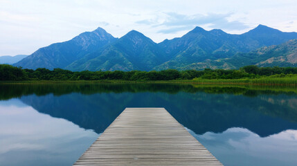 Tranquil reflection of mountains at lake dock nature photography serene landscape clear sky captivating view