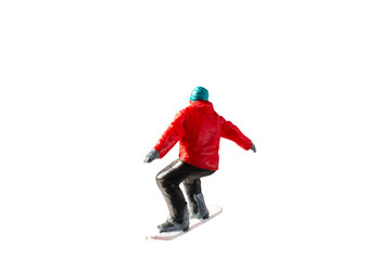Miniature figurine depicting a snowboarder in mid-motion isolate on white background with clipping path