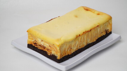 Homemade burnt cheesecake brownies isolated on white background