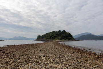 Dec 26,2024,Hong Kong.tombolo on Sharp Island, The tombolo is not always visible as it emerges only when low tide.
