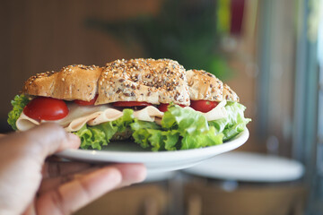 A Delicious Turkey Sandwich Served on a Plate Accompanied by Fresh Vegetables