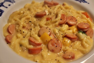 German cuisine: spätzle with cheese sauce and sausages