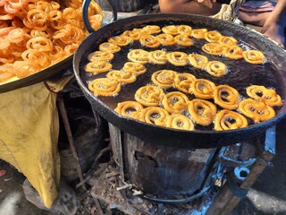 Indian and bengali sweets and snacks Jalebi shop at a local fair during Ratha Yatra at Barasat,  Kolkata, West Bengal, India.