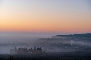 fog over the village in winter