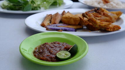 A plate of chili paste to complement the chicken menu and fried tofu with Nasi Uduk. Indonesia food.