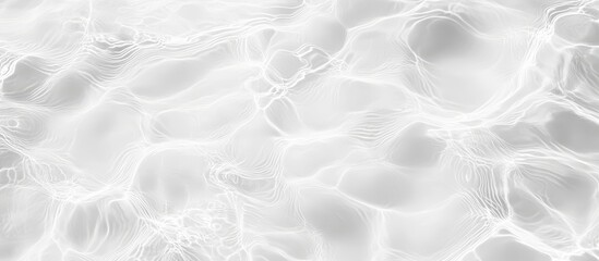 Obraz premium Abstract grayscale image of water surface with light reflections and ripple textures.