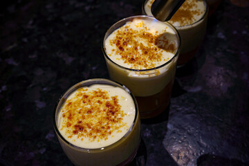 Prepare crème brulée, also known as burnt cream or Trinity cream. Caramelize the sugar layer with a small hand gas burner (flambé burner)
