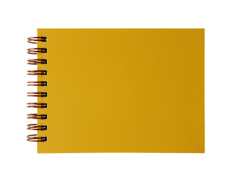 A square yellow notebook with a spiral binding made of copper-colored rings on the left.