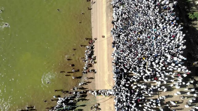 Thousands of Ethiopian people at Timkat parade- Aerial Footge 
Drone view over Large crowd parade dressed in white clothes Ethiopian Timkat Ceremony Ending, Ethiopia,19.1.2020
