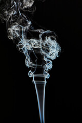 The smoke is thick and dark, creating a mood of mystery and danger