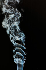 The smoke is thick and dark, creating a mood of mystery and danger