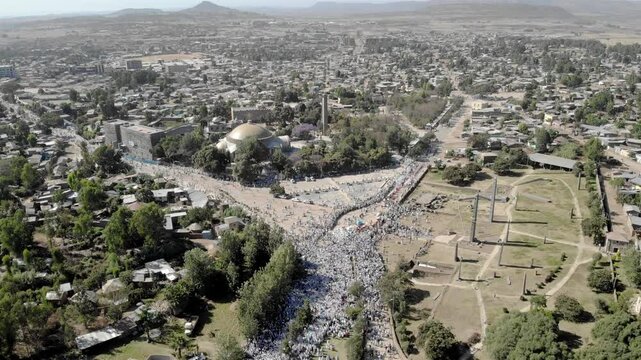 Thousands of Ethiopian people at Timkat parade- Aerial Footge 
Drone view over Large crowd parade dressed in white clothes Ethiopian Timkat Ceremony Ending, Ethiopia,19.1.2020
