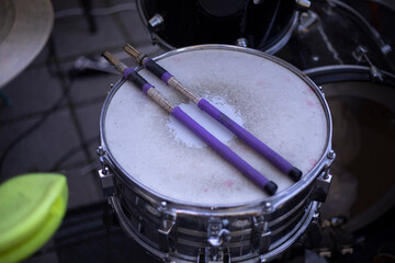 Drumsticks lying on a drum. A percussion musical instrument.