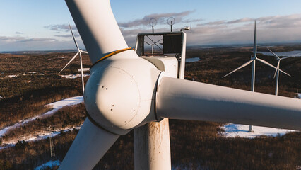 Sunlight hits nacelle of wind turbine producing clean energy