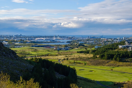A landscape with a city and a body of water