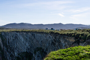 chasm near the ocean with mountain view