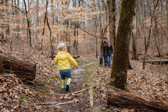 Playful children on winter hike through forest