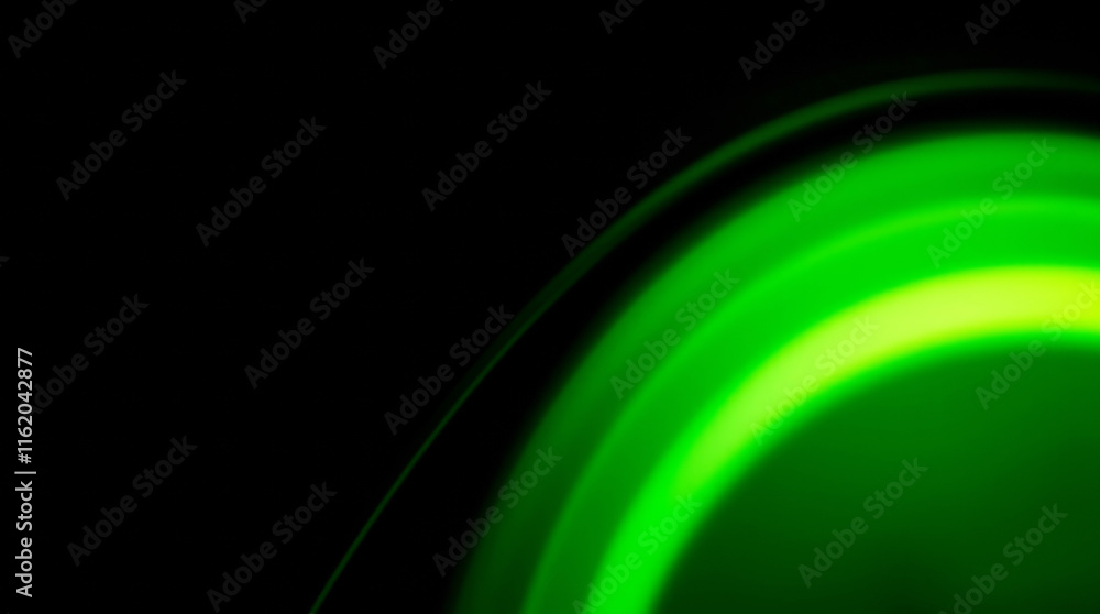 Poster Green light trails creating abstract circular pattern on black background