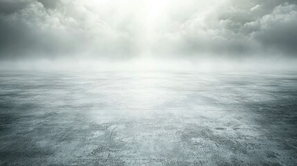 Empty, misty concrete ground under a cloudy sky.