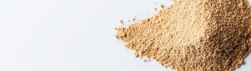 A fine pile of light brown powder against a white background, suggesting a natural ingredient or spice.