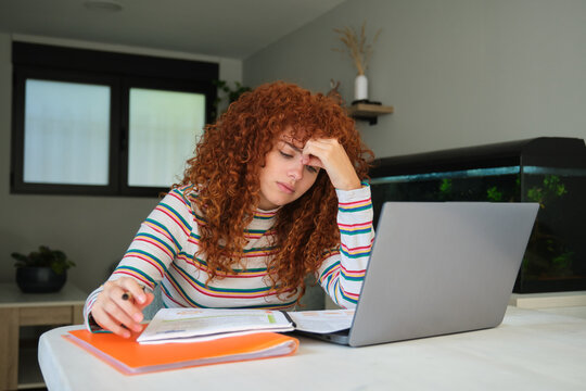 Tired student having headache while studying online at home
