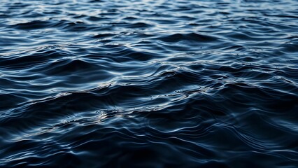 A close-up view of dark water rippling. Abstract dark rippling water texture with circular and linear patterns. 