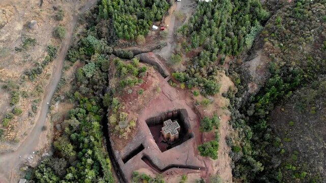 Aerial footage over Saint George Cross shaped rock hewn, Ethiopia
Drone view Saint George Cross shaped rock hewn church, Lalibela, Ethiopia 
